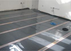 Electric under floor heating foils being fitted
